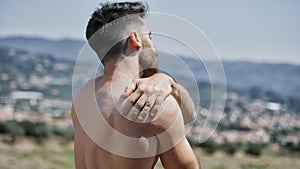 Shirtless Young Man Putting on Sunscreen Cream