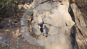 Shirtless young man rock climbing