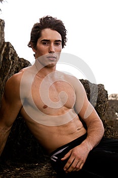 Shirtless Young Man By Rock Formation