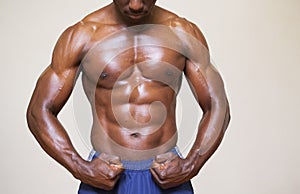 Shirtless young muscular man flexing muscles