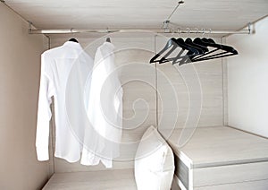 Shirts hanging on built-in cloths racks