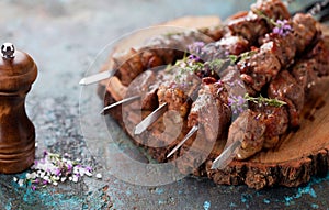 Shish kebab, Grilled lamb meat skewers with spices and oregano flowers on a wooden board