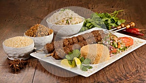 Shish kebab with mixed rice, kibbe and variety of ethnic lebanese food. photo