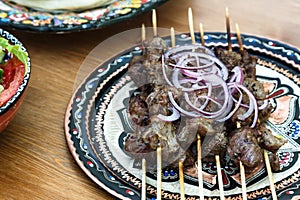 Shish kebab skewers on beautiful traditional plate