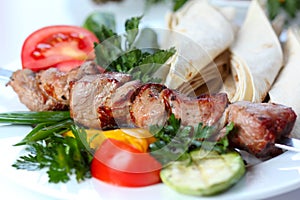 Shish pork kebab with greens and vegetables