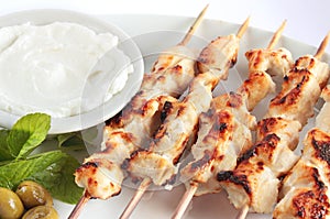 Shish taouk - Chicken shish kebab on white platter photo