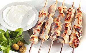 Shish taouk - Chicken shish kebab on white platter photo