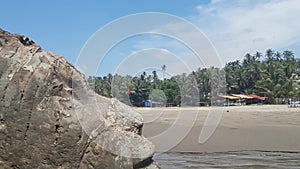 Shiva head carved in a rock on a beach in Goa India