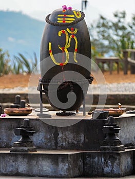 Shiva Lingam, Shiva Lingas with Om symbol painted on, wrapped with Rudraksha in Dhulikhel, Nepal photo