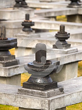 Shiva Lingam stone wrapped around with Rudraksha at meditation maze in Dhulikhel, Nepal photo