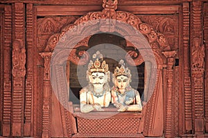 Shiva and Parvati looking down from a balcony.