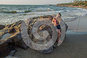 Shiva Rock Carving, North Goa, India. Young woman at Little Vagator Beach