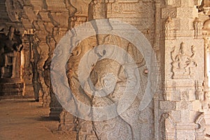 Shiva Virupaksha Temple in Hampi, Karnataka, India. Ancient columns of the temple courtyard. Carving stone figures