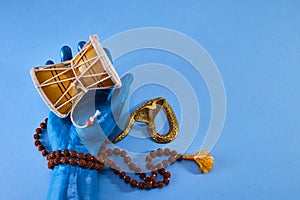 Shivaratri background with Shiva hand and Drum Damroo musical instrument. Maha Shivratri festval.