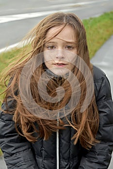 Shivering girl outside in stormy weather