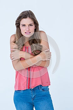 Shivering woman holding her arms