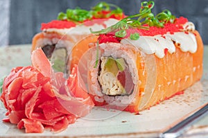 Shizu fusion roll. Wrapped in salmon, with the addition of mozzarella cheese and masago caviar.