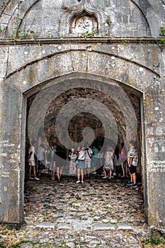 A group of tourists inside the arched corridor in Rozafa Castle