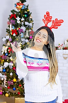 Shock happy excited african american young woman at Christmas tree home background. Happy New Year, Merry Christmas holidays. Gift