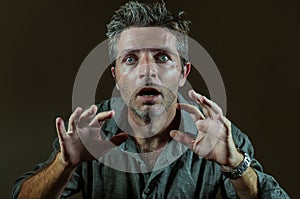 Shock and surprise facial expression portrait of young hypnotized and mesmerized man feeling shocked and surprised looking photo