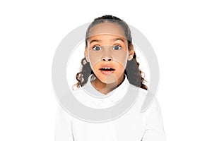 shocked african american schoolgirl looking at camera isolated on white.