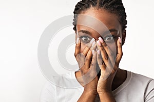 Shocked African Girl Looking At Camera Covering Mouth, White Background