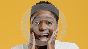 Shocked African Woman Looking At Camera Posing On Yellow Background