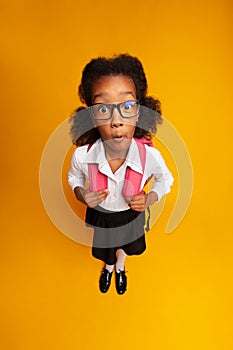 Shocked Afro Schoolgirl Looking At Camera Posing In Studio, High-Angle