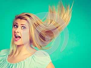 Shocked amazed blonde woman with crazy windblown hair