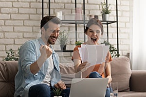 Shocked amazed family couple screaming in delight winning lottery prize