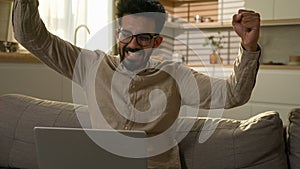 Shocked amazed Indian freelancer businessman astonish wonder excited Arabian guy happy man win laptop online bet job photo