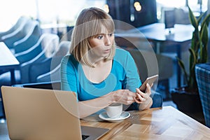 Shocked amazed woman working on laptop, having break, checking social networks reading breaking news