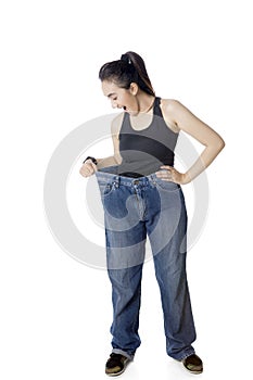 Shocked Arabian woman trying her old jeans