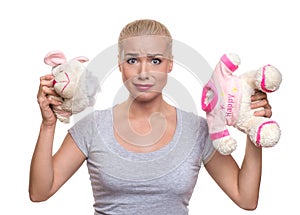 shocked beautiful blonde woman with damaged teddy bear. expression