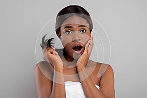 Shocked Black Woman Showing Split Ends Of Her Damaged Hair