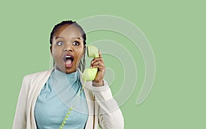 Shocked black woman surprised with news talk on phone