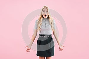 Shocked blonde woman posing isolated