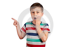 Shocked boy pointing with his finger on something, isolated on white background