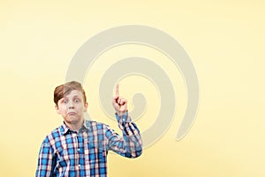 Shocked boy pointing to object or text, template