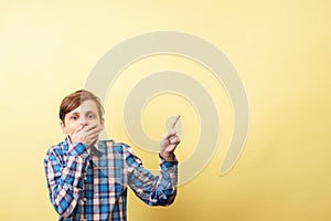 Shocked boy pointing to object or text, template