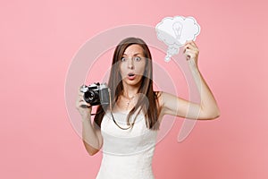 Shocked bride woman in wedding dress hold retro vintage photo camera, Say cloud speech bubble with lightbulb choosing