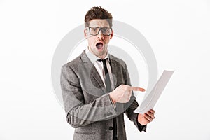 Shocked business man in jacket and eyeglasses holding documents