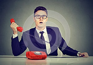 Shocked business man receiving bad news on the phone