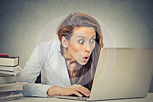 Shocked business woman sitting in front of laptop computer