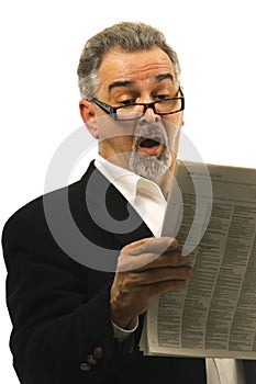 Shocked businessman reads newspaper