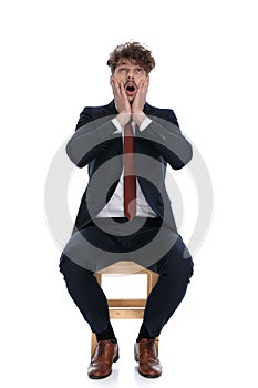 Shocked businessman slapping his face, looking up