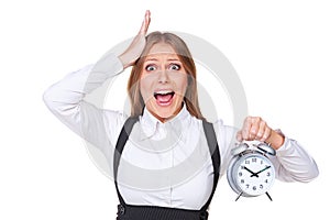 Shocked businesswoman holding alarm clock