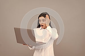 shocked businesswoman with laptop. network administrator hold computer. office manager