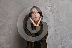 Shocked casual young woman looking at camera