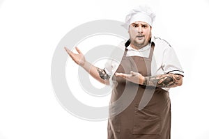 Shocked chef pointing away and looking at camera
